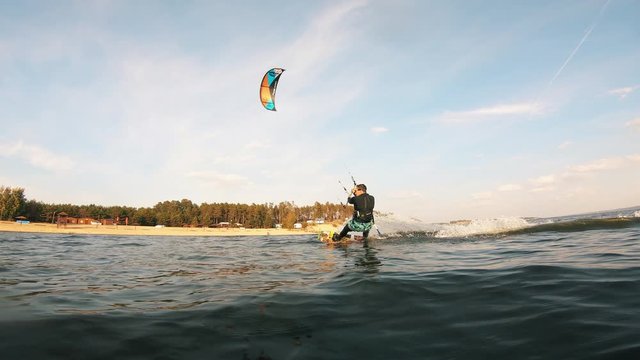Person training with kiteboard on river.