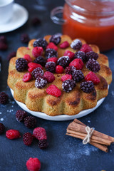 charlotte cake with berries on dark background