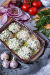 baked meatballs in creamy sauce on grey napkin 