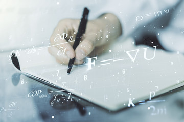 Double exposure of creative scientific formula concept with man hand writing in notebook on background, research and development concept