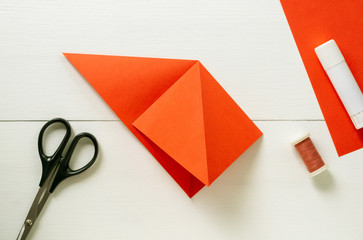 Step by step instructions for making origami paper lantern on christmas tree. Children diy project