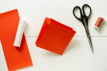 Step by step instructions for making origami paper lantern on christmas tree. Children diy project