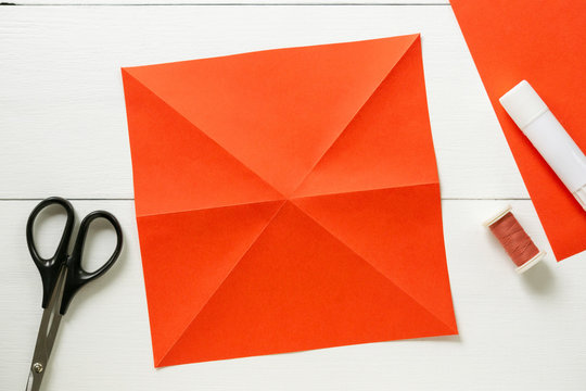 Step by step instructions for making origami paper lantern on christmas tree. Children diy project