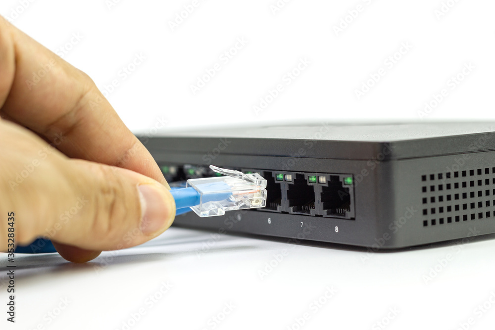 Poster hand of man holding the blue network cables connect port switch on white table concept internet netw