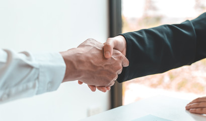Fototapeta na wymiar Financial accountants and marketers shaking hand to congratulate the double-digit real estate performance, Meetings and hand shake concept.....