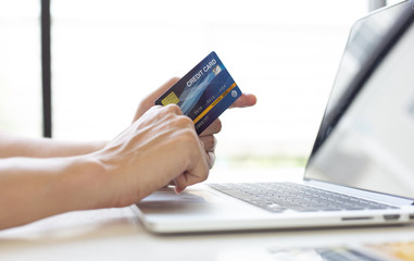 Men use laptop to register online purchases using credit card payments, Convenience in the world of technology and the internet, Shopping online and banking online concept.