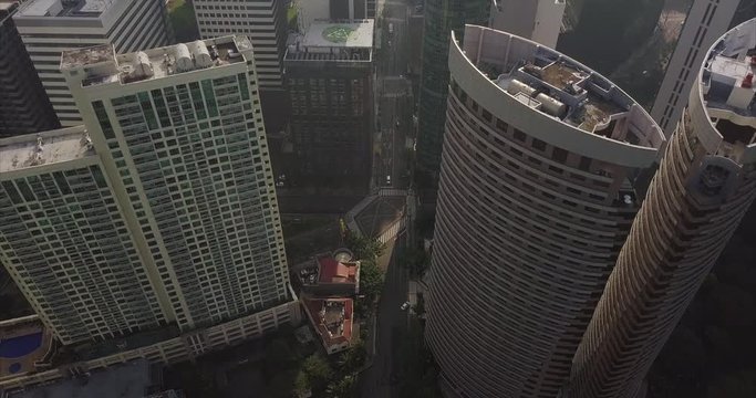 Straight aerial flight above skyscrapers in business district. Tilt up following main avenue's line. City view. Drone, 4K. 

Frame rate: 23.98
Video Codec: ProRes 422HQ
BGC, Taguig, Manila, Philippine