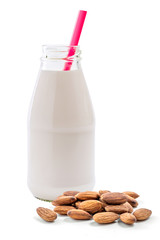 Glass bottle of almond milk with straw isolated on white background
