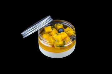 Dessert Homemade panna cotta with mango on black background