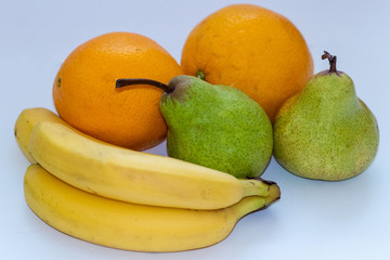 Oranges, pears and bananas on a white isolated background