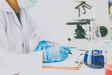  The scientist is recording the scientific value on a note. In an experiment in the LAP room