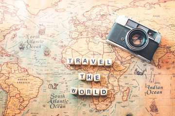 keywords "TRAVEL THE WORLD" are on the world map. Tourism concept