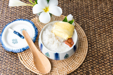 Sweet Sticky Rice With Durian And Coconut Milk Sauce,Thai sweet sticky rice with durian, Thai style tropical dessert,  isolated on white background, selective focus.
