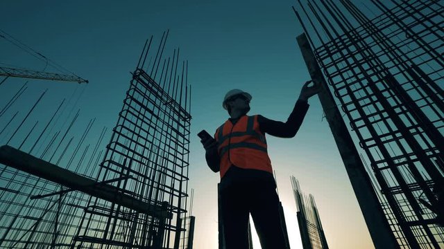 An engineer checks construction site with reinforcement.