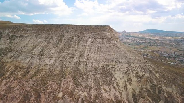 Landscape Of Mount Aktepe, White Hill Surrounded By Rock Formations And Valley In Goreme, Cappadocia, Turkey. - aerial drone shot