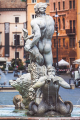 Fototapeta na wymiar Statues of the fountains of Piazza Navona in the historic center of Rome in Italy. Fontana del Moro in the foreground.