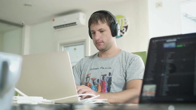 Software Developer Coding on Laptop in Digital Nomad Co Working Space. Travel, Freedom and Remote Work Career Concept.