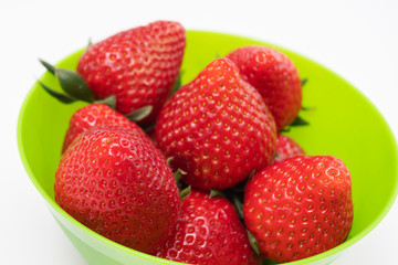 Fototapeta na wymiar Ripe rustic strawberries in a green bowl