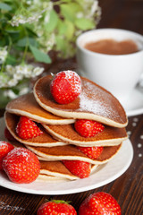 Tasty, only baked pancakes with strawberries on a dark surface, homemade cakes, close-up