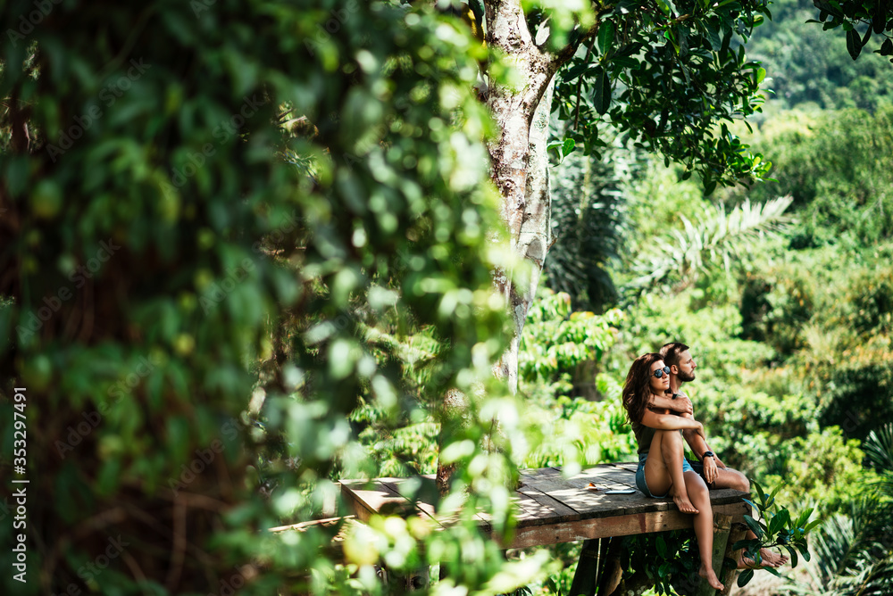 Wall mural couple among the greenery. a couple in love in the tropics. the couple is traveling in asia. beautif