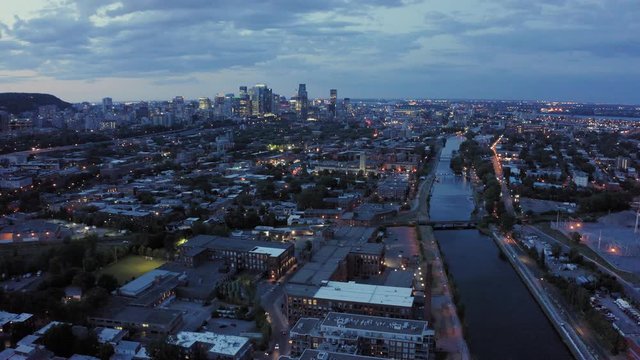 Drone moving towards Montreal's downtown, following the iconic Lachine canal