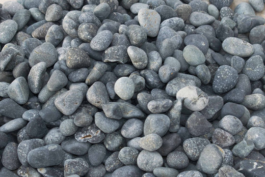 Piled gray cobble stones. Beach rocks - Powered by Adobe