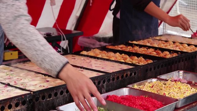 Close Up Japanese Man Cooking Traditional Takoyaki Balls At A Colorful Market Food Stall In Japan