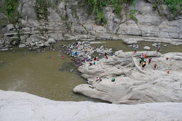 tourist enjoying the water from the foot of the Tangadan waterfall in La Union Pangasinan.
