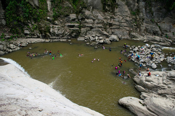 Tourist swimming at the foot of the Tangadan Falls in La Union Pangasinan. People swimming at the lake.