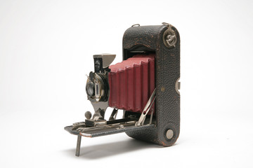 Vintage handheld medium format bellows film camera with viewfinder. Three-quarter view to left