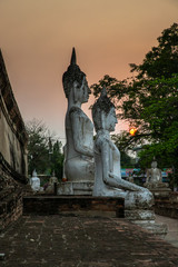 Fototapeta premium Buddha statues at sunset inside Wat Yai Chai Mongkhon, a Buddhist temple of archaeological park, Ayutthaya, Thailand