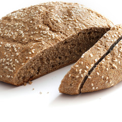 Homemade whole grain round bread isolated on a white background.