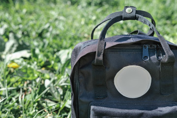 black school bag on a grass. back to school concept. backpack ready to school. education concept. learning at school or univercity.