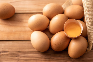 fresh brown chicken eggs on wooden background