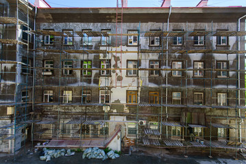 Renovation of the old building, facade in the scaffolding.