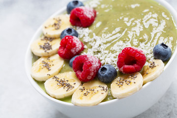 Healthy Breakfast smoothie in a bowl with hemp protein, avocado, banana, coconut, raspberries, blueberries and Chia seeds.