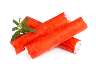 Crab stick isolated on white background. Imitation crab meat with rosemary sprig. Fish product. © vandycandy