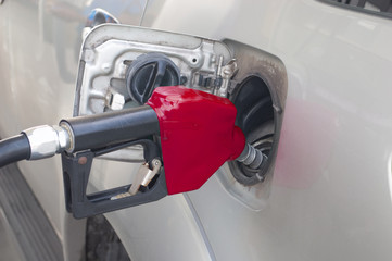 red Fuel nozzle to refill fuel in car at gas station