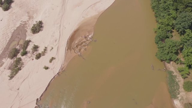 Aerial drone view of Banas river with silt and forest, Madhya Pradesh, India.