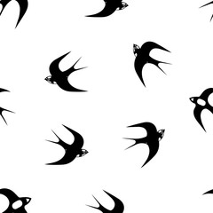 Hand-drawn black vector seamless pattern illustration of group of swallows or martlets are flying on a white background