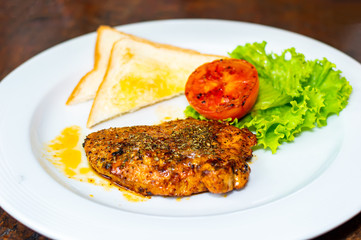 Grilled pork steak and tometo vegetables on dish