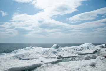 Natural background. Change of seasons.Baikal Lake in May morning.Spring landscape.The view from the rocks in the foreground of a snow-white fragments of ice floes. Northern nature
