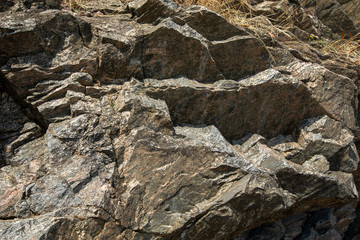 A close up of the surface of the grey stone.Close-up of a rocky cliff. Stones. Background.