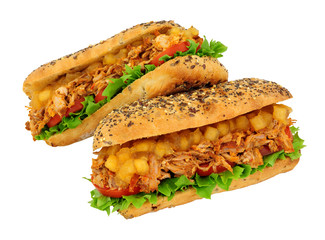 Slow cooked hog roast pork sandwiches in a multigrain topped bread roll with chunky Bramley apple sauce isolated on a white background