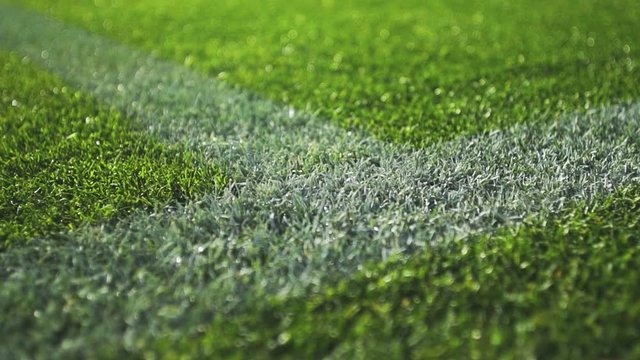 Close up boundary line on a turf football field.