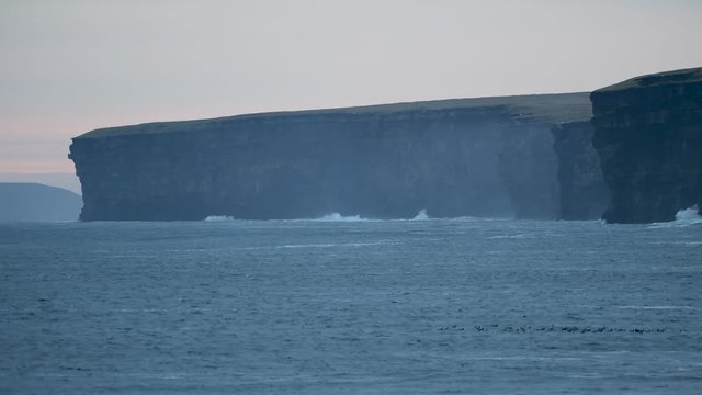 Large areas of exposed cliff face off the coastline of Scotland
