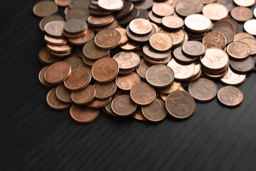 Euro cent coins on wood table.  Selective focus.