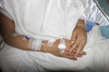 Hand of patient with iv set in hospital