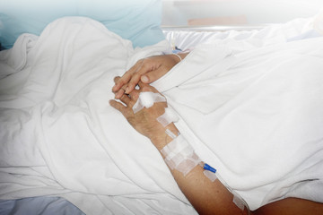 Obraz na płótnie Canvas Hand of patient with iv set in hospital