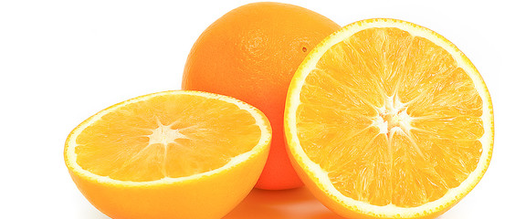 Orange whole and two halves on a white background.